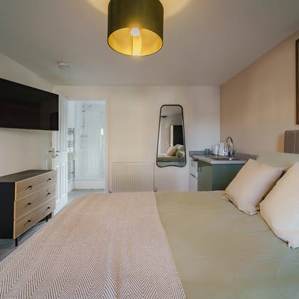 Room 3, TV and door to the en suite