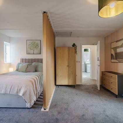 Room 5, double bed behind the timber screen