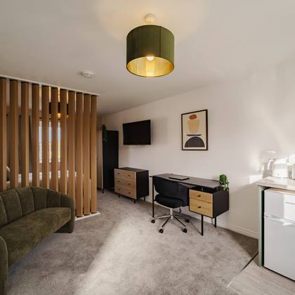 Room 6, sofa, desk and kitchenette